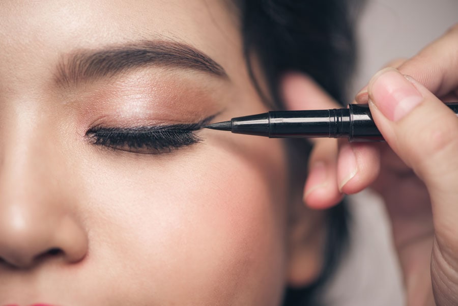apply eyeliner to cover lash glue
